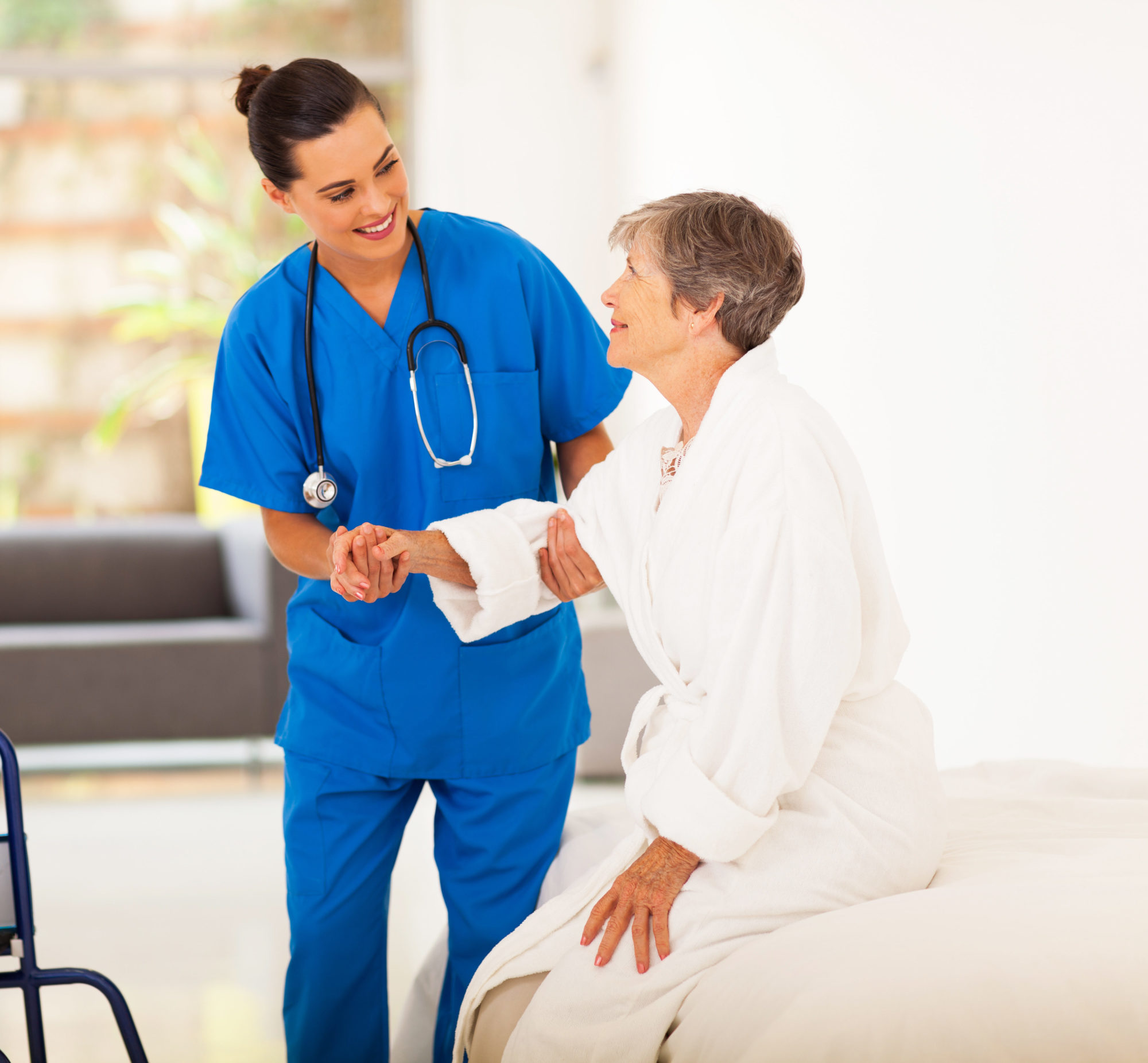 A nurse helping a patient. 